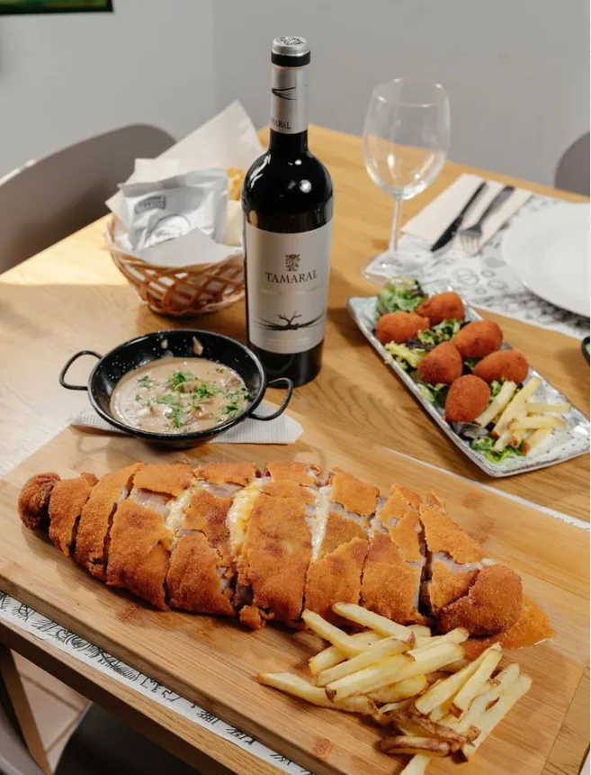 Cachopo de la casa con vino y croquetas